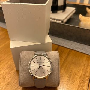 MICHAEL KORS woman’s watch with gray leather band. New in box.